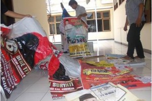 Salah seoraqng petugas kepolisian resort Kuningan saat membereskan baligho yang dirusak warga gunung keling.