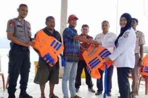 Kasi Potensi Keselamatan Laut Mayor Bakamla Tri Rah Astuti, S.E saat memberikan puluhan lifejacket kepada nelayan setempat..